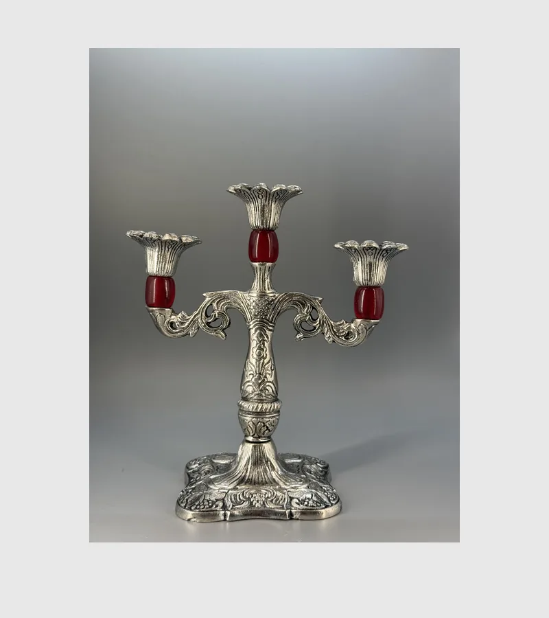 Silver Jagmag tri candle stand lit for Diwali, engraved base just visible